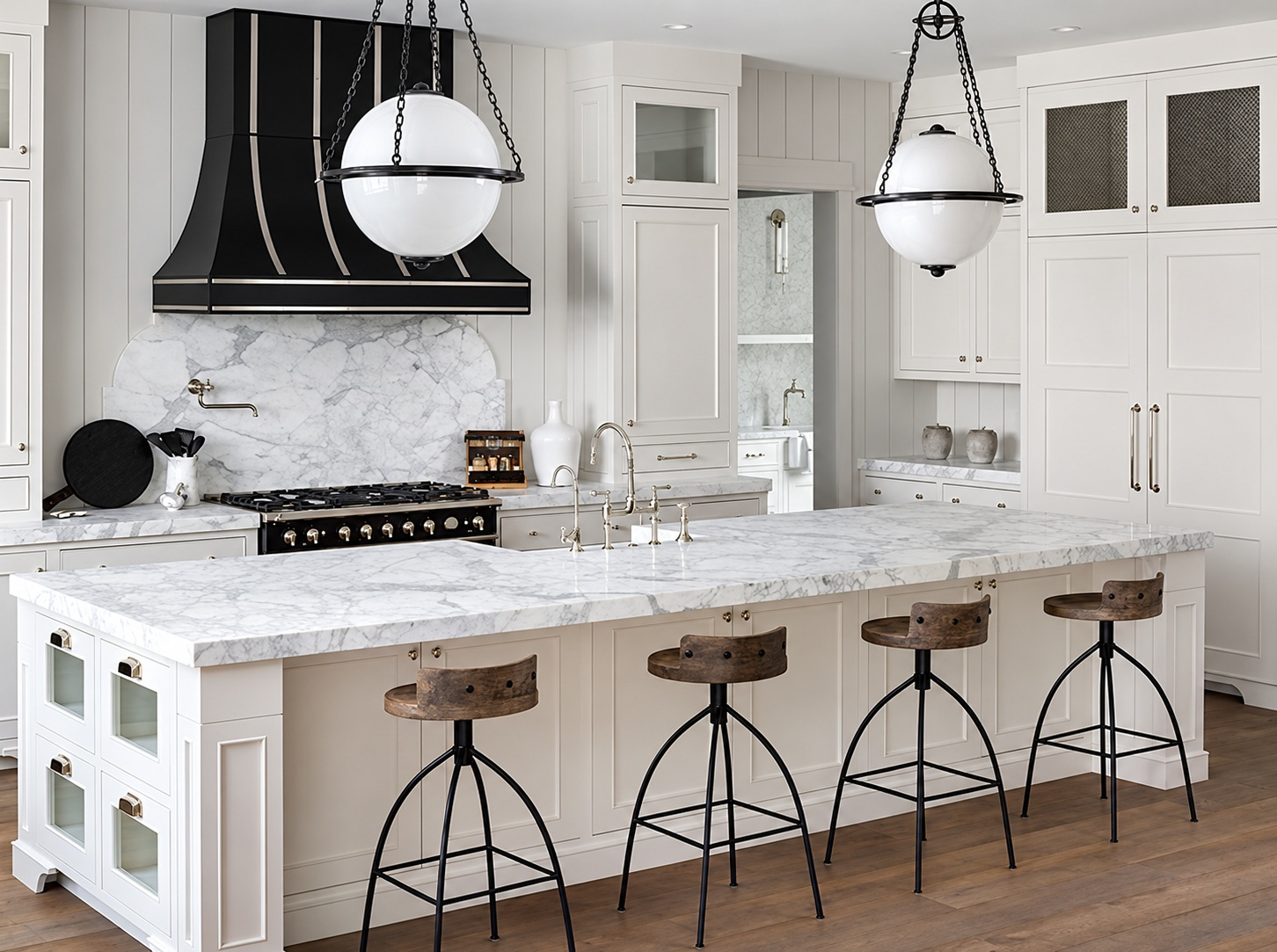 TwoHawks kitchen with a white veined stone island and matching backsplash